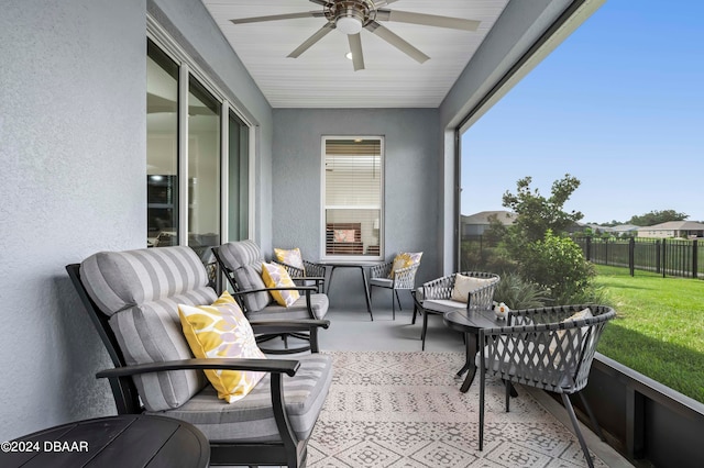 sunroom / solarium featuring ceiling fan