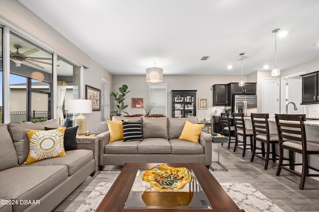 living room featuring ceiling fan and light wood-type flooring