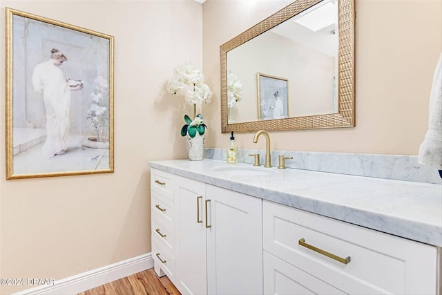 bathroom featuring hardwood / wood-style flooring and vanity