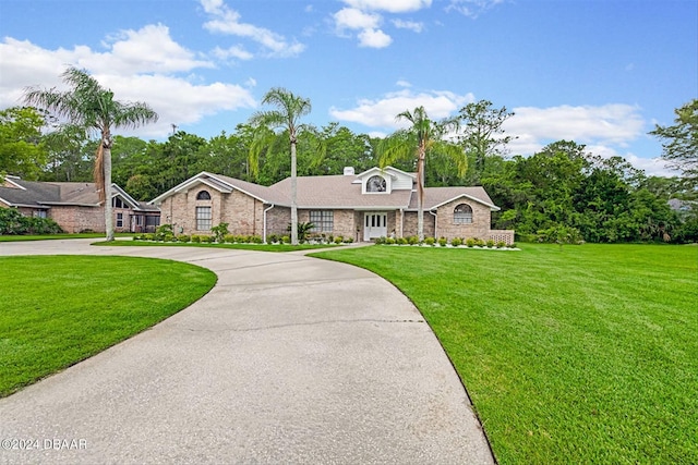 ranch-style house with a front lawn