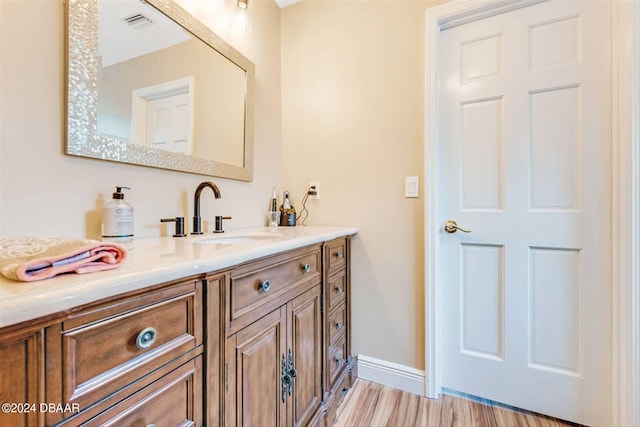 bathroom featuring hardwood / wood-style floors and vanity