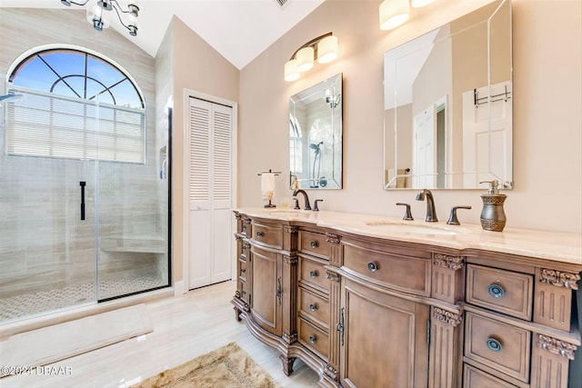 bathroom with vanity, an enclosed shower, and vaulted ceiling