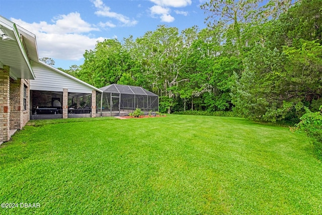 view of yard with glass enclosure