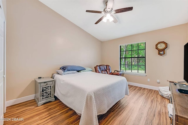 bedroom featuring hardwood / wood-style floors, ceiling fan, and vaulted ceiling