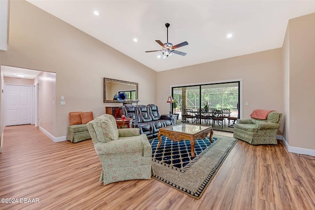 living room with ceiling fan, light hardwood / wood-style flooring, and high vaulted ceiling