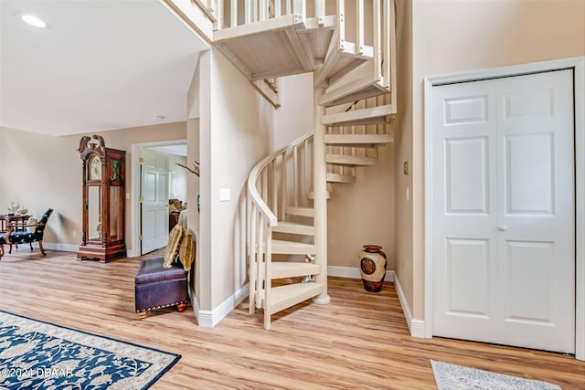 stairway with hardwood / wood-style floors