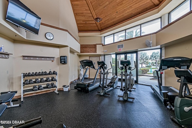 exercise room featuring a high ceiling and wood ceiling