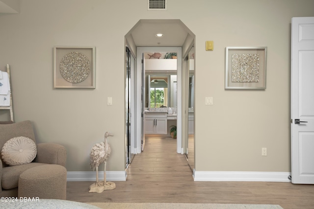 corridor featuring light hardwood / wood-style floors