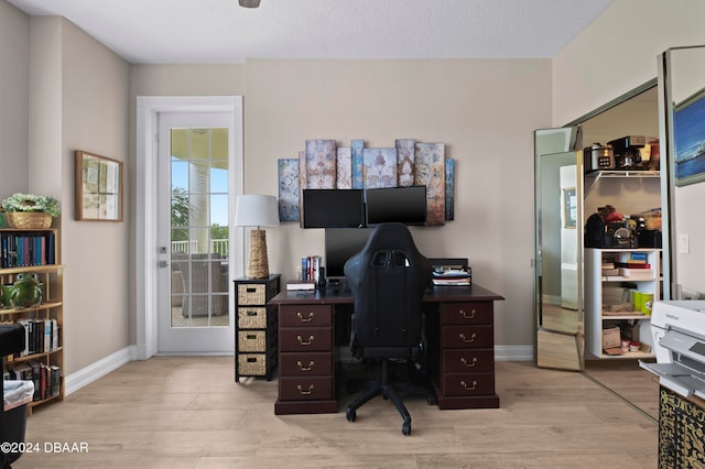 office space featuring light hardwood / wood-style floors and a textured ceiling