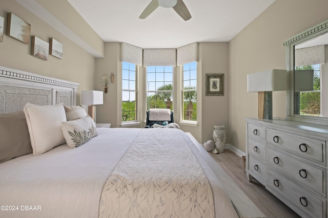 bedroom with light hardwood / wood-style floors and ceiling fan