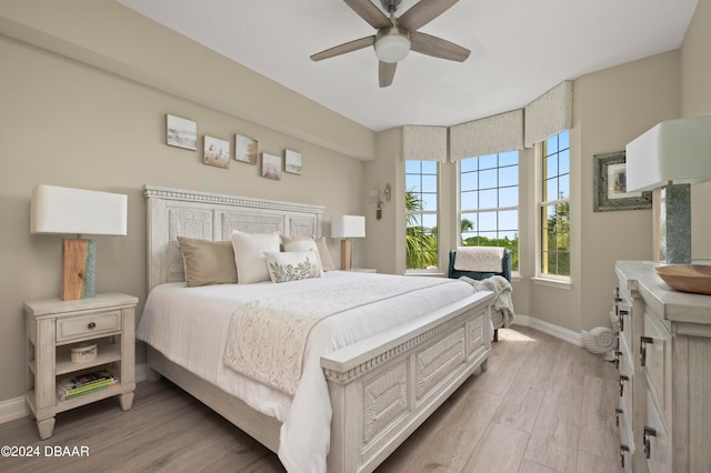 bedroom with ceiling fan and light hardwood / wood-style floors