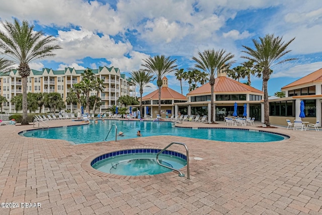 view of pool with a patio and a community hot tub