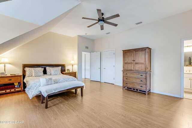 bedroom featuring light wood-type flooring, ceiling fan, and connected bathroom