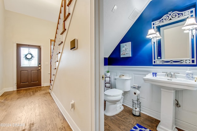 bathroom with toilet, sink, and hardwood / wood-style flooring