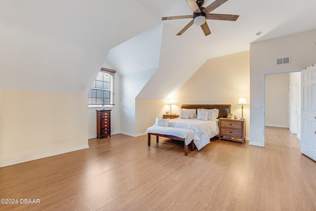 bedroom featuring light hardwood / wood-style floors, ceiling fan, and vaulted ceiling