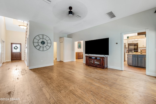 unfurnished living room featuring ceiling fan and light hardwood / wood-style floors