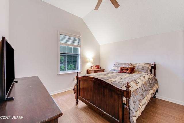 bedroom featuring hardwood / wood-style floors, ceiling fan, and vaulted ceiling