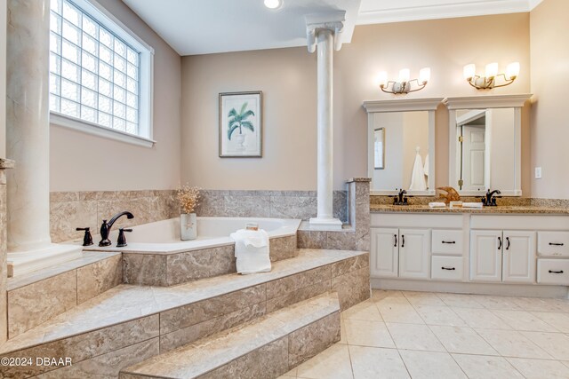 bathroom with ornate columns, tile patterned floors, ornamental molding, tiled bath, and vanity