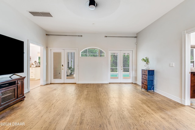 living room featuring light wood-type flooring, french doors, and ceiling fan