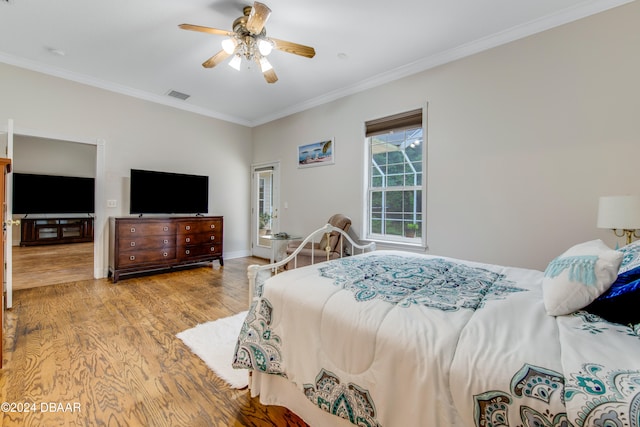 bedroom featuring ceiling fan, light wood-type flooring, and ornamental molding