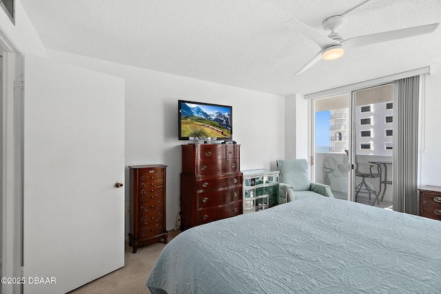 2987 S Atlantic Ave Unit 901, Daytona Beach Shores, FL 32118 - carpeted bedroom featuring a textured ceiling, ceiling fan, and access to outside