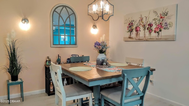 dining area with baseboards and a chandelier