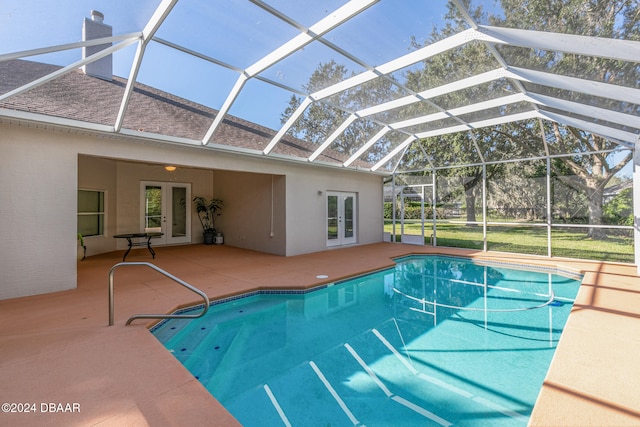 view of swimming pool with a patio area, glass enclosure, and french doors