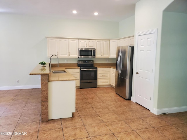 7 Old Mcduffie Cir, Ormond Beach, FL 32174 - kitchen featuring stainless steel appliances, a sink, a peninsula, baseboards, and light tile patterned floors