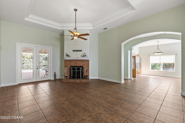 7 Old Mcduffie Cir, Ormond Beach, FL 32174 - unfurnished living room featuring tile patterned floors, a high ceiling, ceiling fan, arched walkways, and french doors