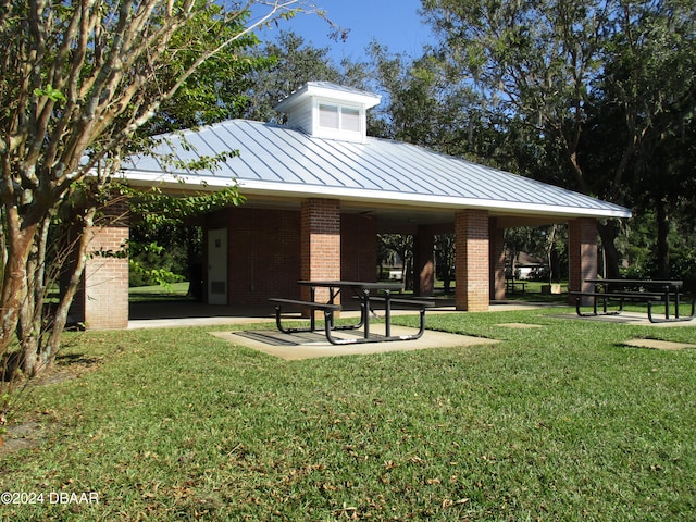 view of home's community with a yard and a patio area