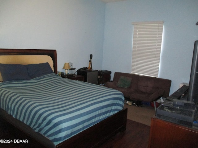 bedroom with dark hardwood / wood-style flooring