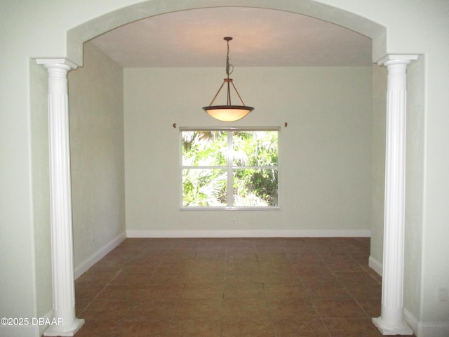 7 Old Mcduffie Cir, Ormond Beach, FL 32174 - unfurnished room with dark tile patterned floors, arched walkways, and baseboards