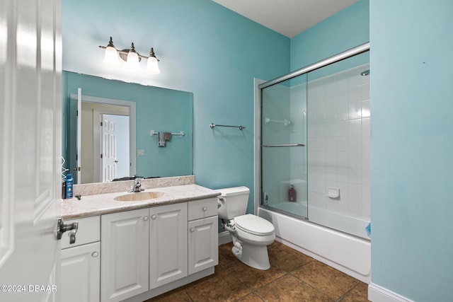 full bathroom featuring vanity, bath / shower combo with glass door, tile patterned floors, and toilet