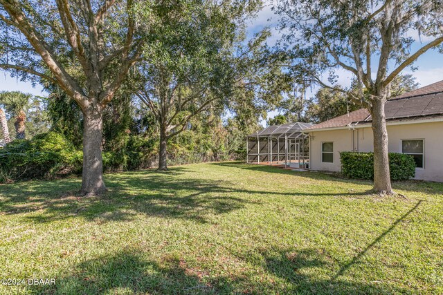 view of yard featuring a lanai