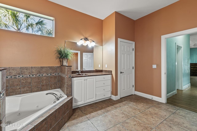 7 Old Mcduffie Cir, Ormond Beach, FL 32174 - bathroom featuring vanity, a jetted tub, and baseboards
