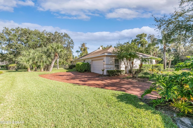 7 Old Mcduffie Cir, Ormond Beach, FL 32174 - view of green lawn featuring an attached garage and decorative driveway