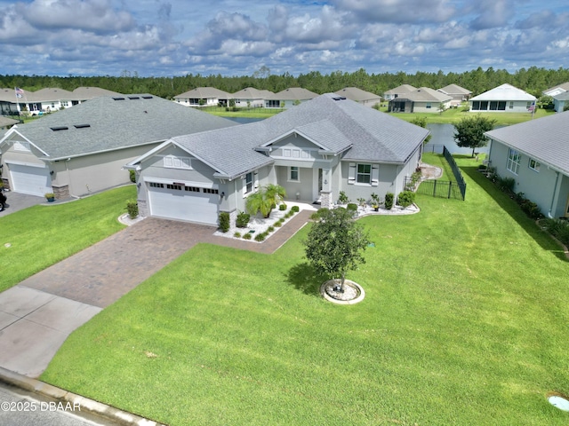 24 Shear Water Trl, Ormond Beach, FL 32174 - view of front facade with a residential view, a shingled roof, driveway, a garage, and stucco siding