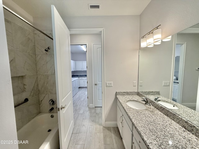 24 Shear Water Trl, Ormond Beach, FL 32174 - bathroom with vanity, wood finished floors, baseboards, and shower / tub combination