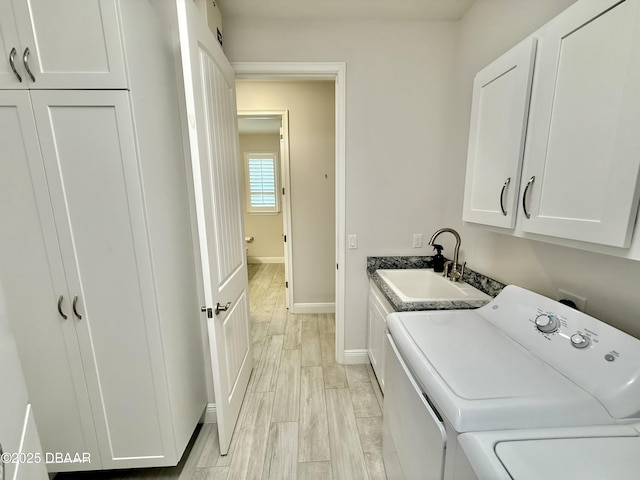 24 Shear Water Trl, Ormond Beach, FL 32174 - laundry room with cabinet space, baseboards, separate washer and dryer, and light wood-type flooring