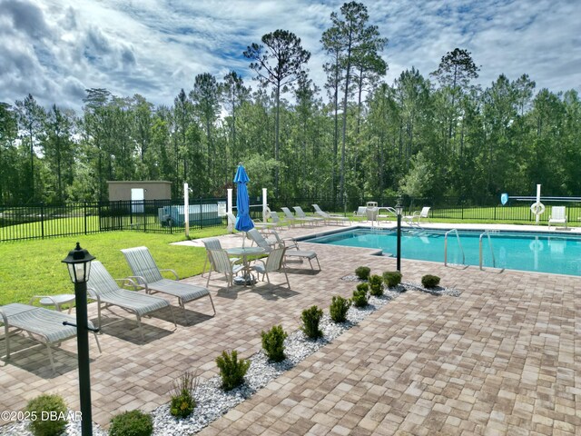 24 Shear Water Trl, Ormond Beach, FL 32174 - community pool with a patio area and view of wooded area
