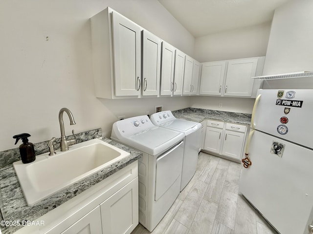 24 Shear Water Trl, Ormond Beach, FL 32174 - washroom featuring cabinet space, washing machine and dryer, and light wood-style flooring