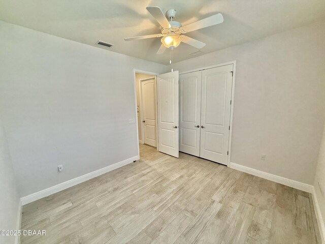 24 Shear Water Trl, Ormond Beach, FL 32174 - unfurnished bedroom featuring baseboards, light wood finished floors, a closet, and a ceiling fan