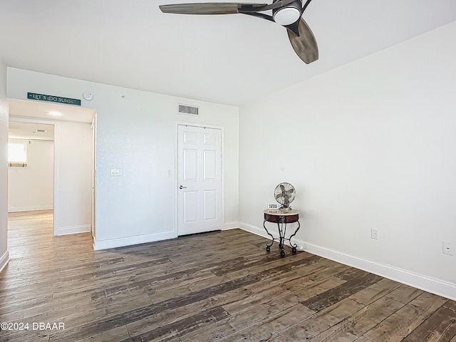 unfurnished room featuring dark hardwood / wood-style floors and ceiling fan