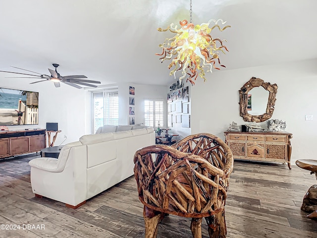 living room featuring ceiling fan with notable chandelier and hardwood / wood-style flooring