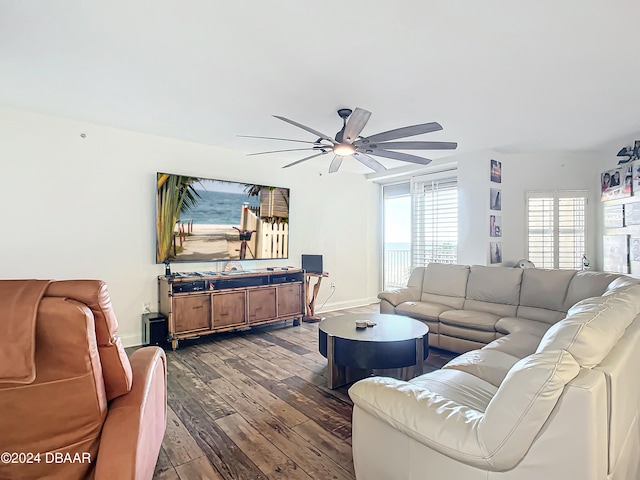 living room featuring ceiling fan and dark wood-type flooring