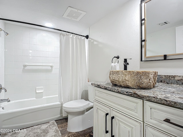 full bathroom with shower / bathtub combination with curtain, hardwood / wood-style floors, vanity, and toilet