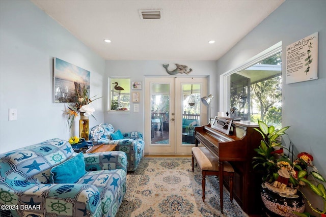 sitting room with carpet flooring and french doors