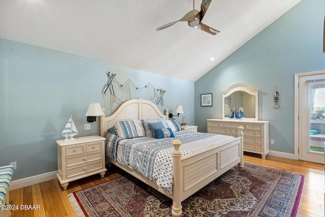 bedroom with hardwood / wood-style flooring, ceiling fan, a textured ceiling, and vaulted ceiling