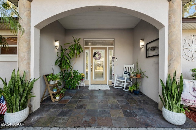 view of exterior entry featuring a patio