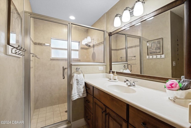 bathroom featuring vanity and a shower with door